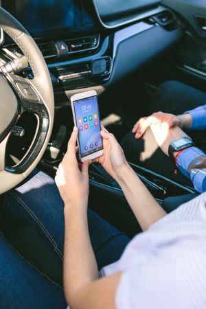 Woman and boyfriend using mobile in the car