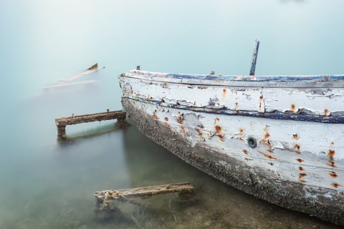 Old rusty boat in misty water