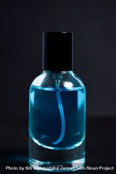 Light blue perfume bottle in dark studio 5oDElx