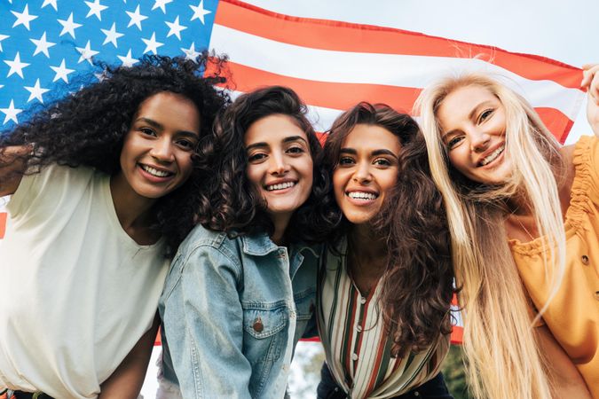 Cheerful female friends celebrating the 4th of July outdoors