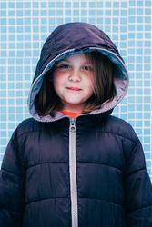 Girl in warm clothes standing in empty pool