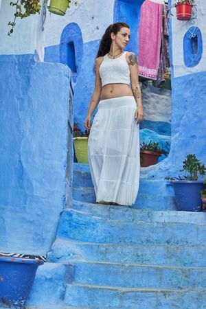 Woman on steps between ancient buildings