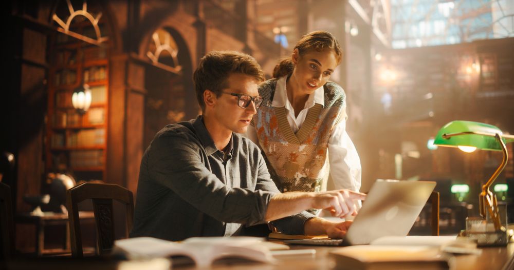Female and Male Students Studying in a College Library.