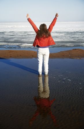 Young adult woman outdoors enjoying icy landscape