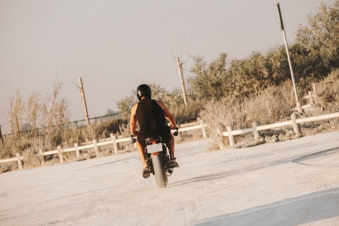 Strong man driving motorcycle