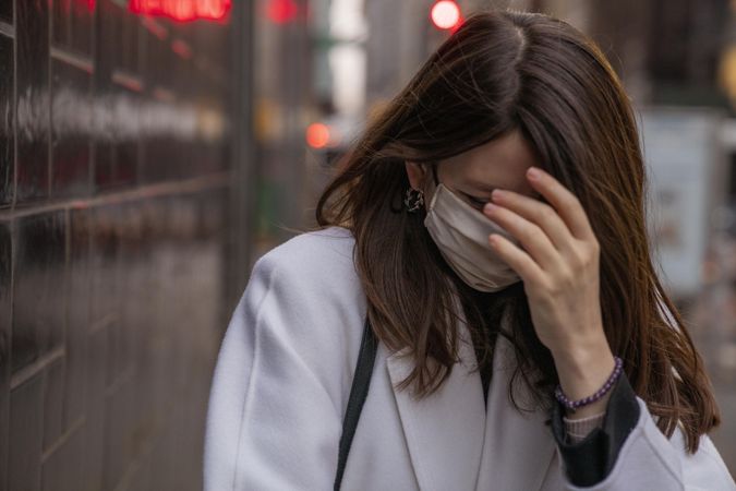 Woman covering her face