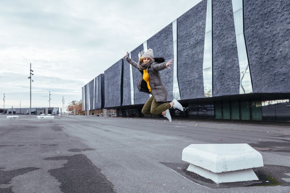 Blonde woman jumping on the street