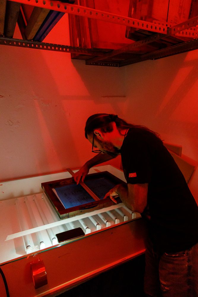 Artist doing drying screen in dark room