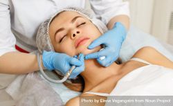 Woman having facial beauty treatment with machine on her chin 5zWwQ4