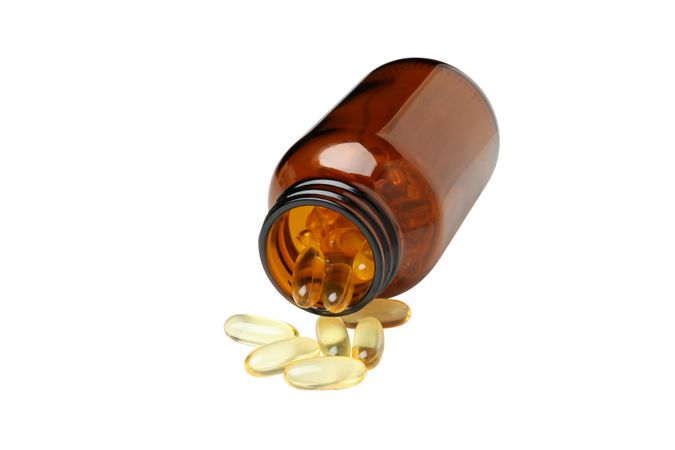 Brown bottle with omega pills, isolated on blank background