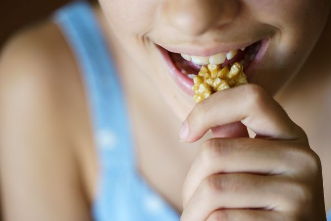 Teenager eating walnuts