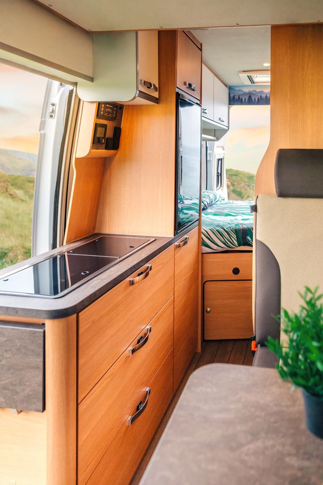 Inside of motorhome camper with door open to scenic view, vertical