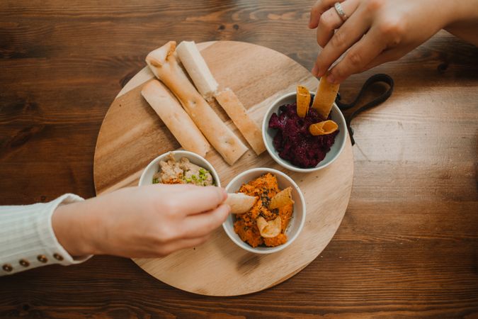 Different tasty sauces on round wooden stand