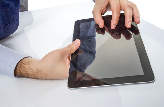 Man fingers touching screen on digital tablet