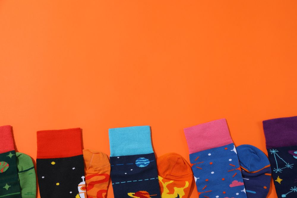 Casual clothes and wearing concept - socks, clothes for foot