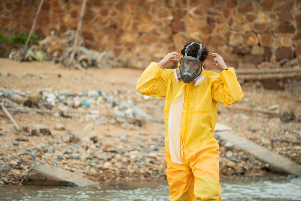 Environment scientist wearing chemical protective cloth and mask before working