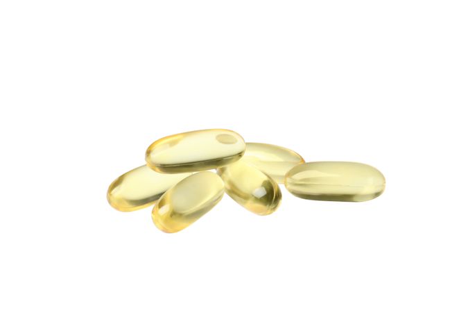 Omega pills close-up, isolated on blank background