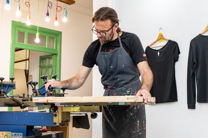 Artist printing screen in workshop