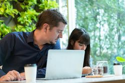 Man and woman having meeting in a green cafe