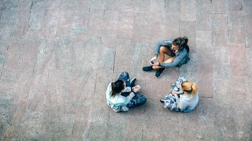 Female runners sitting on the ground after training