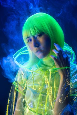 Asian woman smoking in fluorescent light