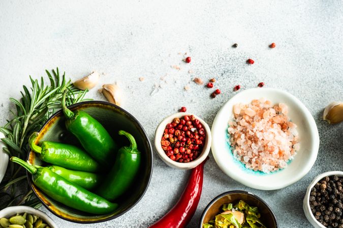 Bowl of green peppers with other vegetables with seasonings & seeds