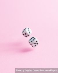 Dice falling over pink background 49Vwmb