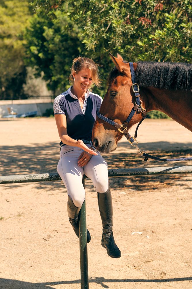 Content horsewoman with horse on paddock