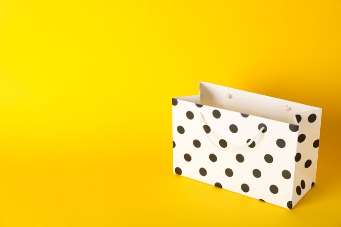 Paper bag on color background, space for text