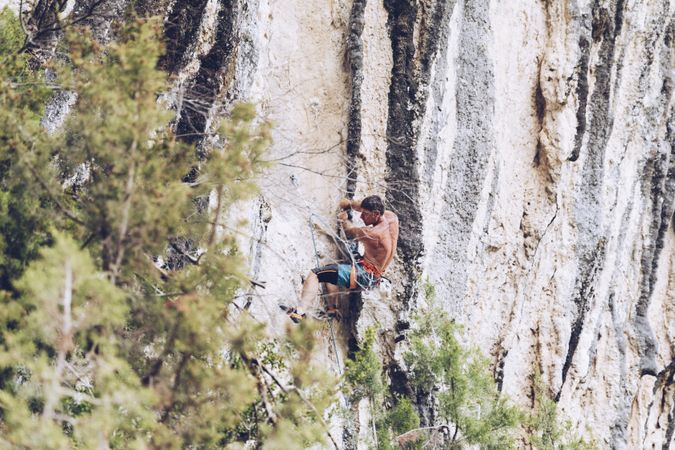 Anonymous man climbing rock