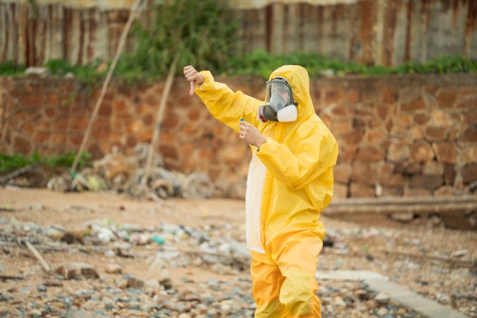 Environment scientist with waste water sample in tube showing thumb down.