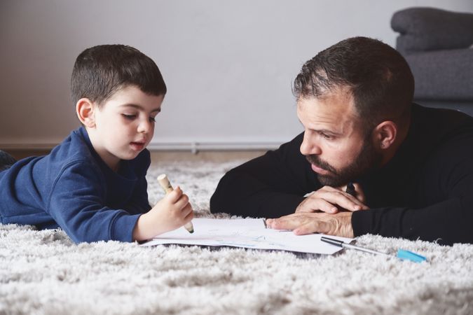 Father and son drawing on floor