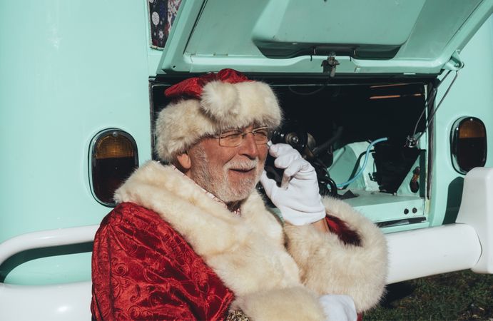 Santa Claus resting by old van
