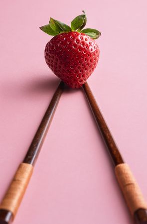 Ripe strawberry and bamboo chopsticks