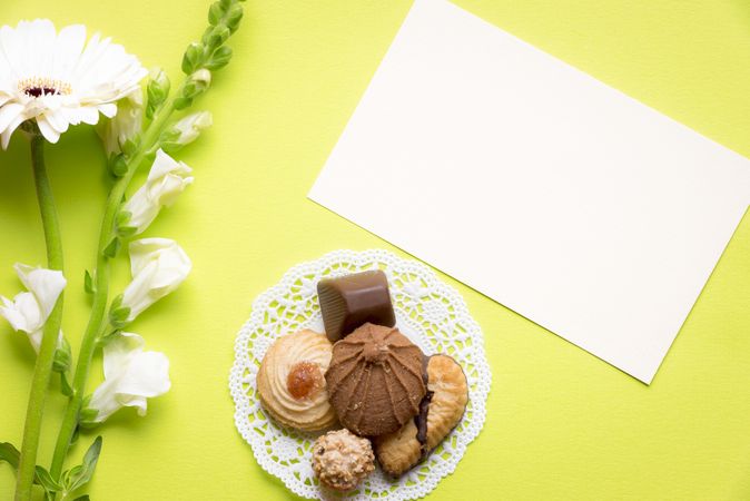 Top view of blank message card with cookies and flowers
