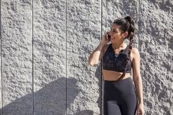 Smiling woman talking on smartphone in sunny day