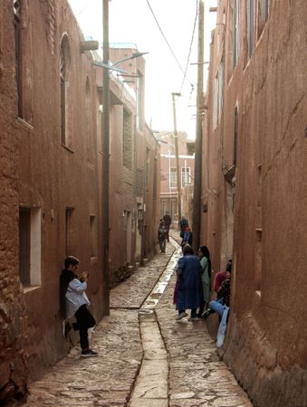 People standing in an alley of residential neighborhood in Iran