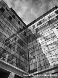 Monochrome photo of corner glass building 0Vy1Yb