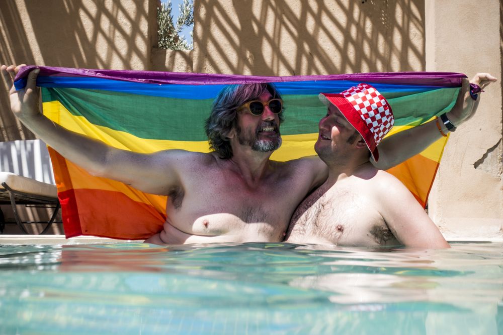 Happy gay couple in swimming pool
