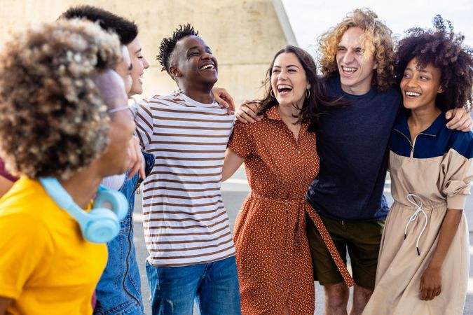 Multi-ethnic young friends laughing together outdoors