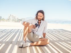 Man using smartphone on beach