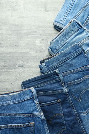 Folded jeans on a wooden background