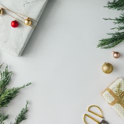 Christmas layout made of presents, branches, baubles on light background