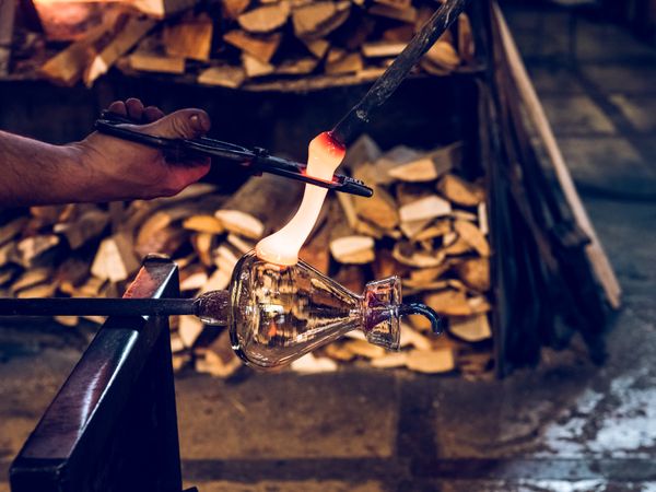 Unrecognizable craftsman making glass teapot