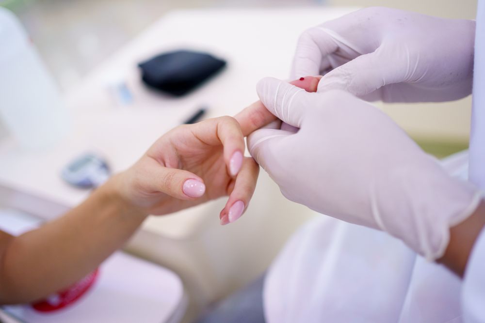 Close up hand being pricked for blood sugar test