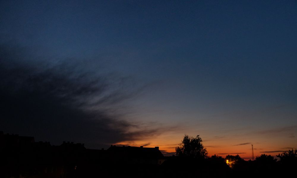 Dark sky at sunset with tree & building shadows