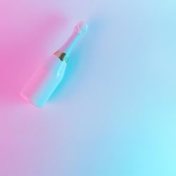 Champagne bottle with colorful ultraviolet holographic neon lights