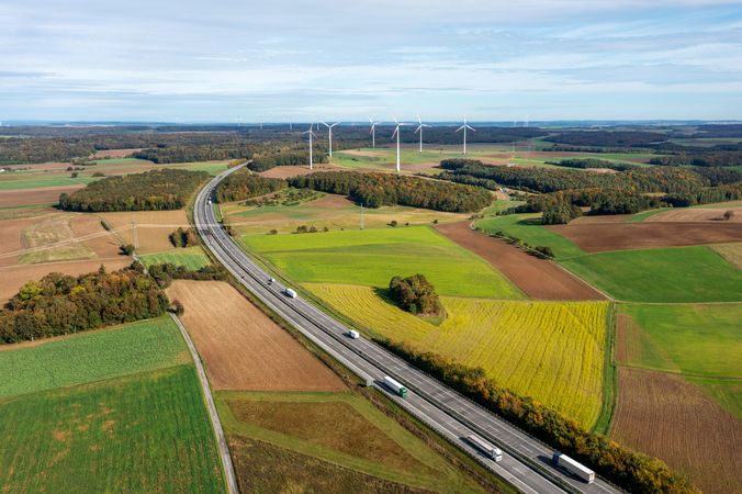 Drone shot with german highway and wind turbines in autumn scenery