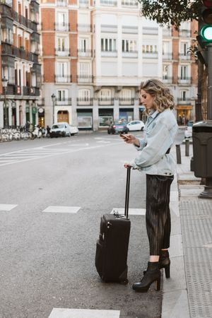 Cheerful female tourist crossing street