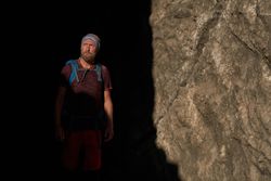 Mature male hiker in mountain cave